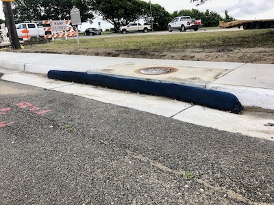 Compost Filter Sock installed for curb inlet protection on a road project