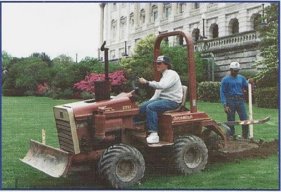 Craig Nun and Jim Ross install silt fence with trencher