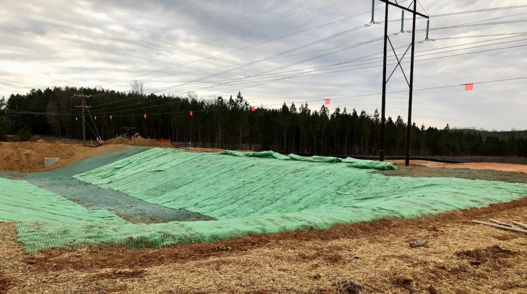 Turf reinforcement blanket installed lateral to transmission line